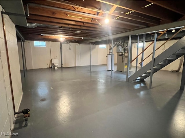 213 Kenmore Ave SE, Warren, OH 44483 - basement with stairway, gas water heater, heating unit, and a sink