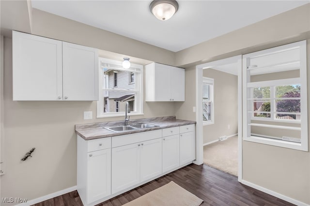 180 Glenn St, Barberton, OH 44203 - kitchen featuring a sink, dark wood finished floors, white cabinets, and baseboards