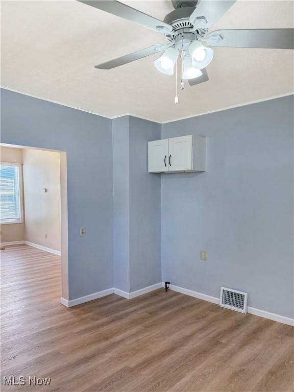 5417 Brow Ave, Newburgh Heights, OH 44105 - empty room featuring light wood-style flooring, ceiling fan, and baseboards