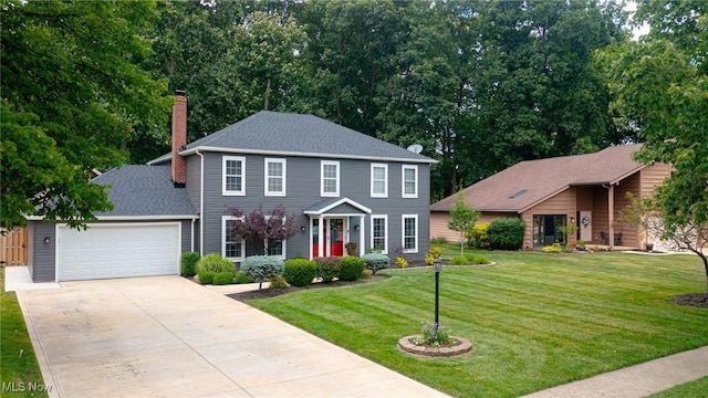 20686 Wildwood Ln, Strongsville, OH 44149 - colonial inspired home featuring driveway, a chimney, an attached garage, a front yard, and a shingled roof