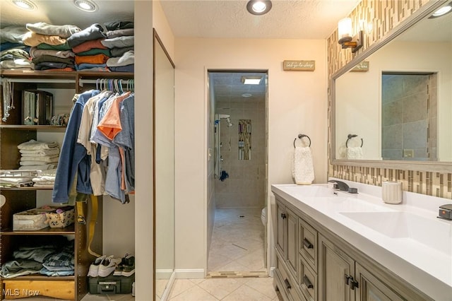 20686 Wildwood Ln, Strongsville, OH 44149 - full bathroom featuring double vanity, tile patterned flooring, tiled shower, recessed lighting, and a textured ceiling