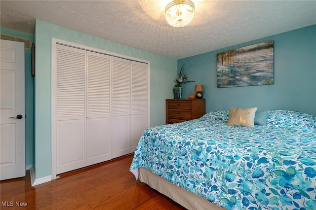 20686 Wildwood Ln, Strongsville, OH 44149 - bedroom featuring wood finished floors, a closet, and a textured ceiling