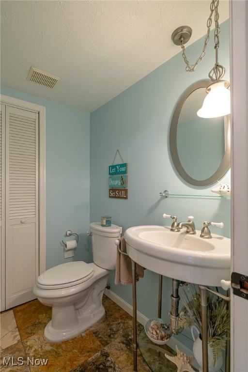 20686 Wildwood Ln, Strongsville, OH 44149 - bathroom featuring toilet, a closet, and baseboards