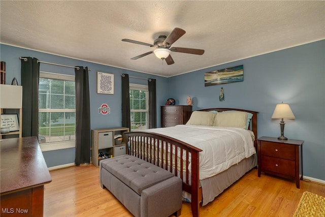 20686 Wildwood Ln, Strongsville, OH 44149 - bedroom featuring wood finished floors, a textured ceiling, baseboards, and a ceiling fan