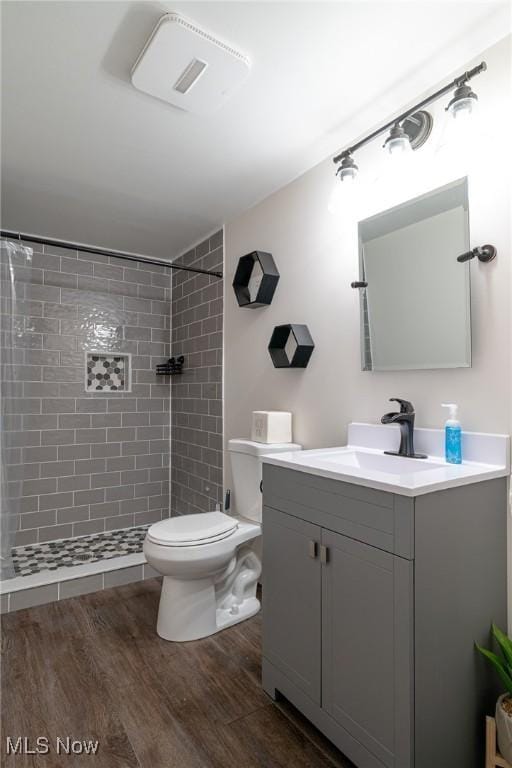 20686 Wildwood Ln, Strongsville, OH 44149 - full bathroom with vanity, a tile shower, toilet, and wood finished floors