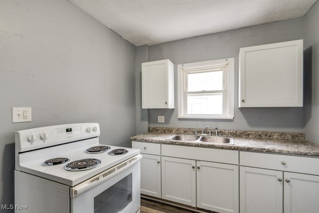 1866 17th St SW, Akron, OH 44314 - kitchen featuring white electric range oven, a sink, white cabinetry, and light countertops