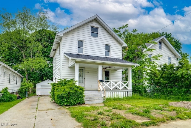 1866 17th St SW, Akron, OH 44314 - american foursquare style home with a porch, an outbuilding, and a detached garage