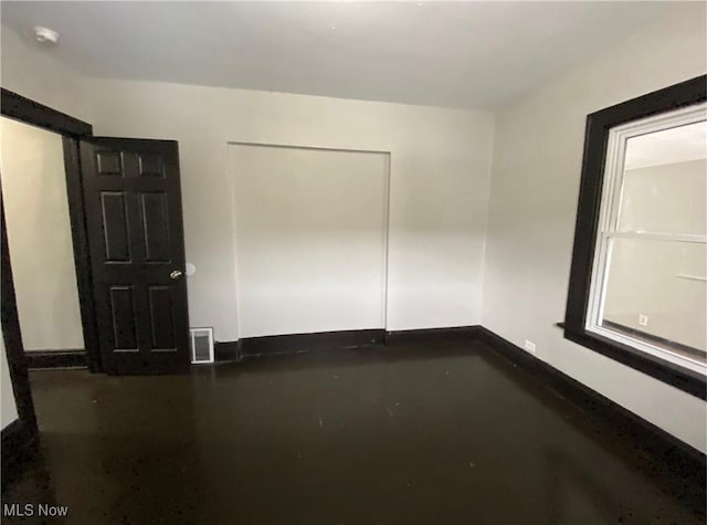 2179 W 106th St, Cleveland, OH 44102 - empty room featuring concrete floors, baseboards, and a smoke detector