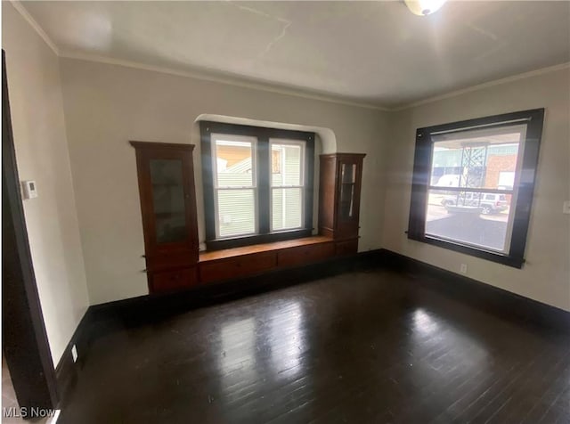 2179 W 106th St, Cleveland, OH 44102 - empty room featuring dark wood finished floors, crown molding, and baseboards