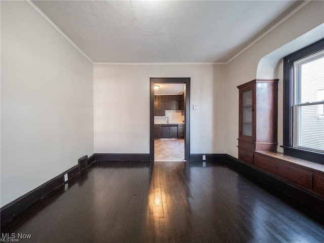 2179 W 106th St, Cleveland, OH 44102 - empty room featuring wood-type flooring, ornamental molding, and baseboards