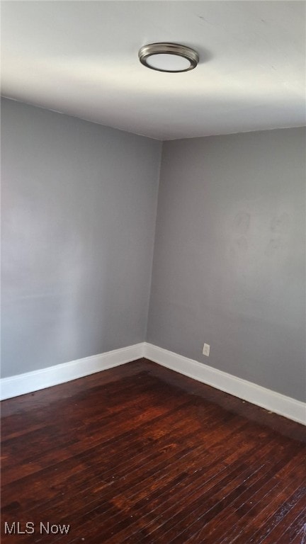 3301 W 94th St, Cleveland, OH 44102 - spare room featuring baseboards and dark wood-style floors