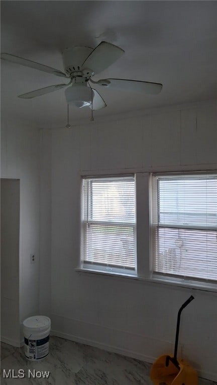 3301 W 94th St, Cleveland, OH 44102 - spare room with baseboards, light marble finish flooring, and a ceiling fan