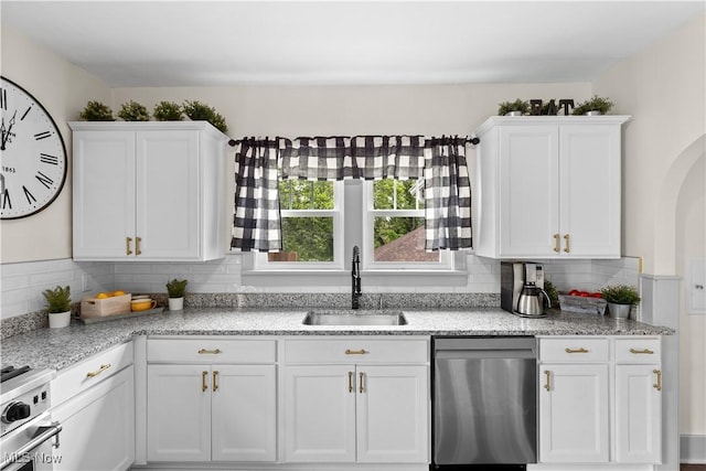 3652 Brightway St, Weirton, WV 26062 - kitchen featuring appliances with stainless steel finishes, a sink, white cabinets, tasteful backsplash, and light stone counters