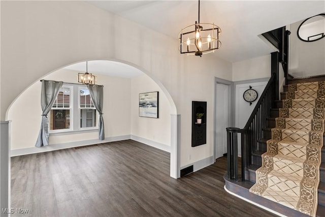 3652 Brightway St, Weirton, WV 26062 - foyer entrance with a chandelier, arched walkways, dark wood finished floors, stairs, and a towering ceiling