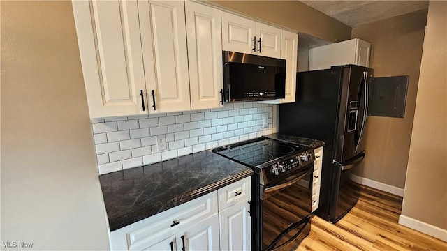 3970 Royal Liverpool Dr Unit A, Uniontown, OH 44685 - kitchen featuring black appliances, baseboards, decorative backsplash, light wood finished floors, and white cabinetry