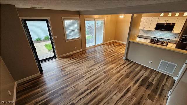 3970 Royal Liverpool Dr Unit A, Uniontown, OH 44685 - kitchen featuring black microwave, wood finished floors, baseboards, white cabinetry, and a textured ceiling
