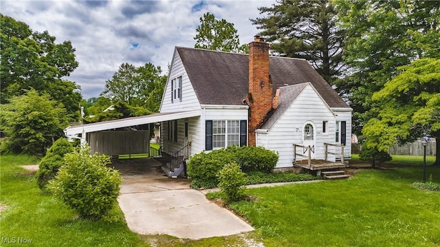 2200 7th Ave, Parkersburg, WV 26101 - view of home's exterior featuring a yard, driveway, a chimney, an attached carport, and roof with shingles