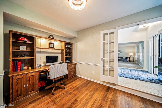20393 Wildwood Ln, Strongsville, OH 44149 - office area with french doors, dark wood-type flooring, and baseboards