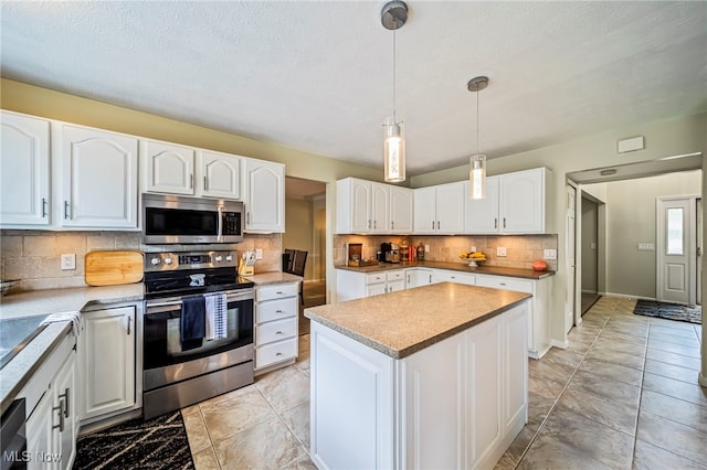 20393 Wildwood Ln, Strongsville, OH 44149 - kitchen with stainless steel appliances, backsplash, white cabinetry, and a center island
