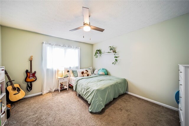 20393 Wildwood Ln, Strongsville, OH 44149 - carpeted bedroom featuring baseboards, a textured ceiling, and ceiling fan