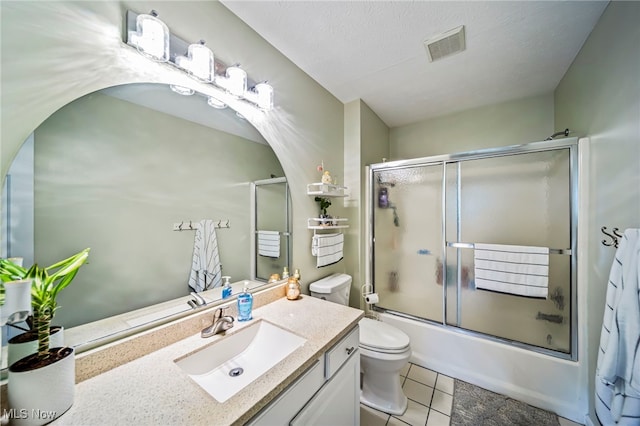 20393 Wildwood Ln, Strongsville, OH 44149 - full bathroom with vanity, toilet, bath / shower combo with glass door, and tile patterned floors