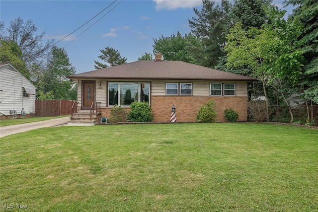 6351 W 130th St, Parma Heights, OH 44130 - view of front of house featuring brick siding, a chimney, and concrete driveway