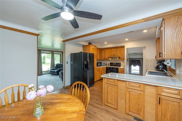6351 W 130th St, Parma Heights, OH 44130 - kitchen with black fridge, range, a sink, ventilation hood, and a peninsula