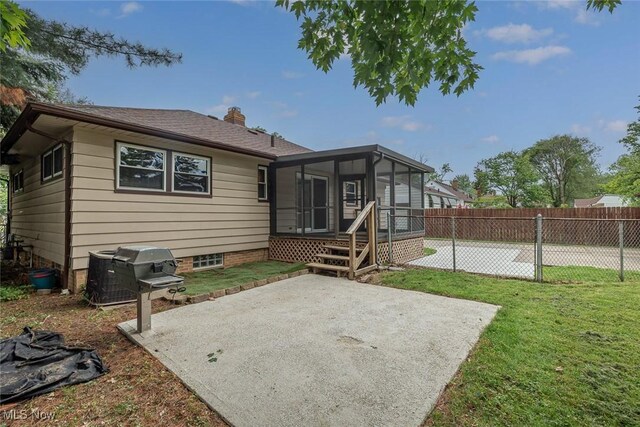 6351 W 130th St, Parma Heights, OH 44130 - back of house with a sunroom, a patio area, and a chimney