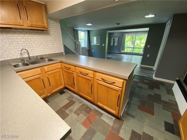 7121 Fable SW, Sherrodsville, OH 44675 - kitchen featuring a peninsula, a sink, decorative backsplash, light countertops, and healthy amount of natural light