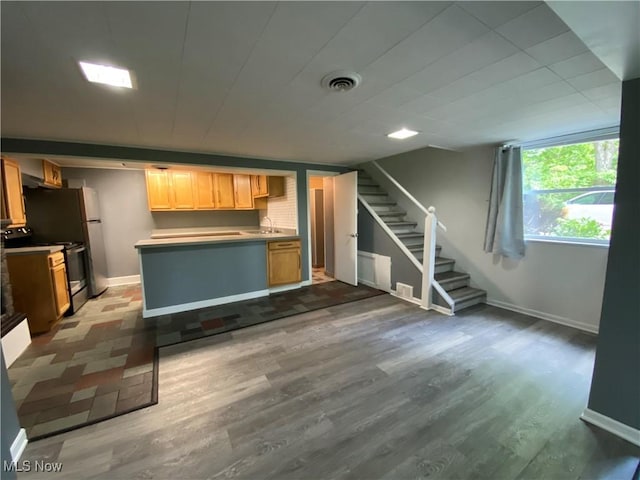 7121 Fable SW, Sherrodsville, OH 44675 - kitchen featuring black electric range, wood finished floors, baseboards, and a sink