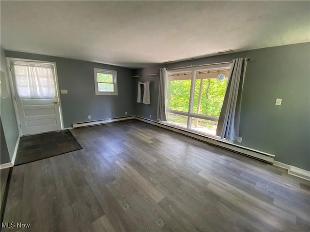 7121 Fable SW, Sherrodsville, OH 44675 - unfurnished living room with wood finished floors, a baseboard heating unit, baseboards, and a baseboard radiator