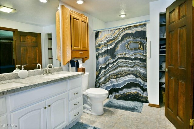 2942 Barclay Messerly Rd, Southington, OH 44470 - bathroom featuring double vanity, toilet, tile patterned floors, and recessed lighting