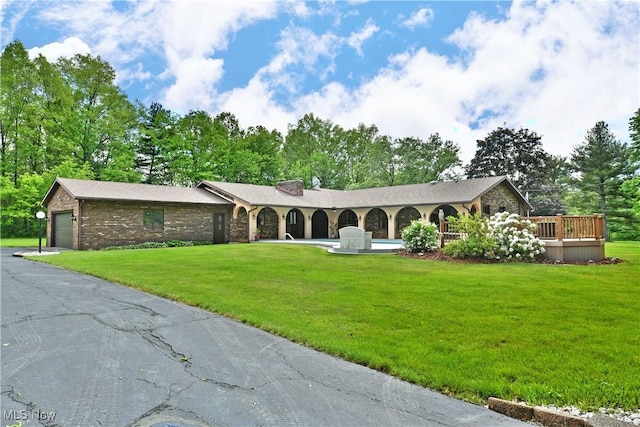 2942 Barclay Messerly Rd, Southington, OH 44470 - ranch-style house featuring a front lawn, asphalt driveway, a chimney, and view of scattered trees