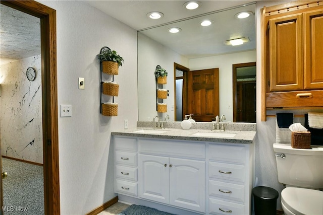 2942 Barclay Messerly Rd, Southington, OH 44470 - bathroom featuring double vanity, baseboards, toilet, and recessed lighting