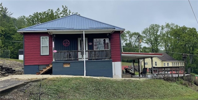 13929 Old Glory Rd, Lore City, OH 43755 - view of front of home with metal roof, a front yard, and a standing seam roof