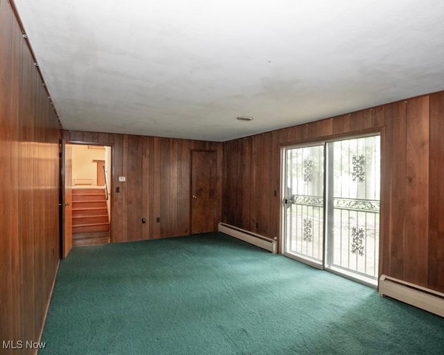 433 University Ave, Elyria, OH 44035 - unfurnished room featuring baseboard heating, carpet flooring, wood walls, and stairway