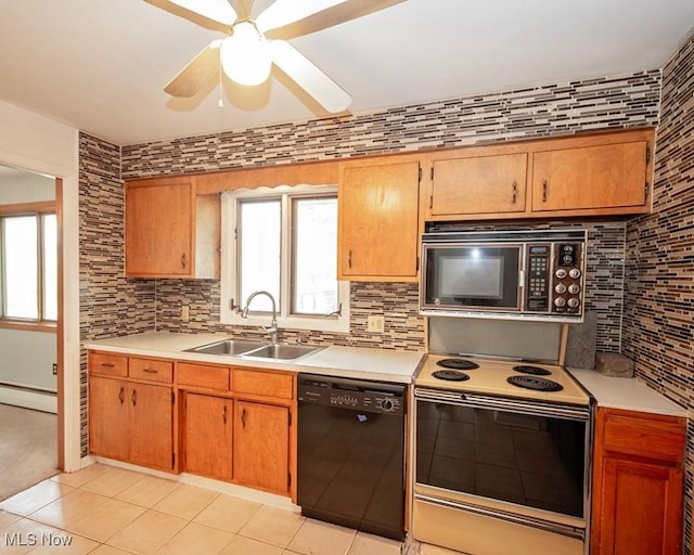 433 University Ave, Elyria, OH 44035 - kitchen featuring black appliances, a sink, light tile patterned flooring, a baseboard radiator, and decorative backsplash