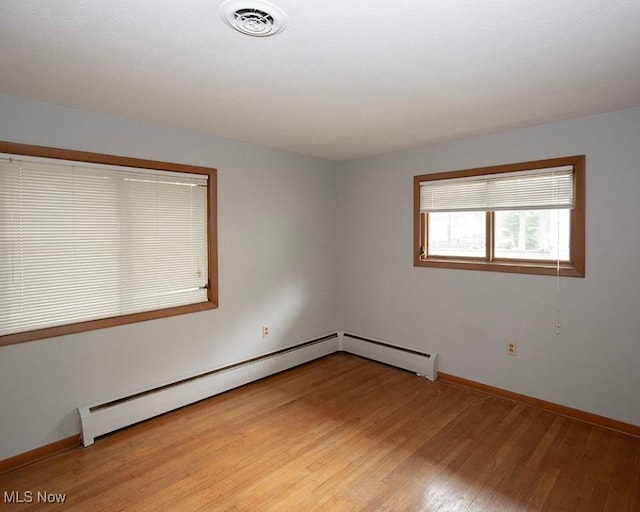 433 University Ave, Elyria, OH 44035 - empty room featuring light wood finished floors, baseboards, and a baseboard radiator