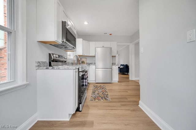 2186 Jackson Blvd, University Heights, OH 44118 - kitchen featuring appliances with stainless steel finishes, white cabinets, baseboards, light wood finished floors, and recessed lighting