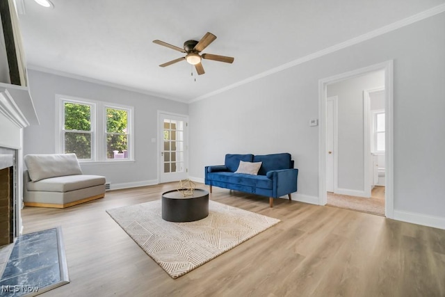 2186 Jackson Blvd, University Heights, OH 44118 - living area featuring crown molding, ceiling fan, wood finished floors, baseboards, and a fireplace