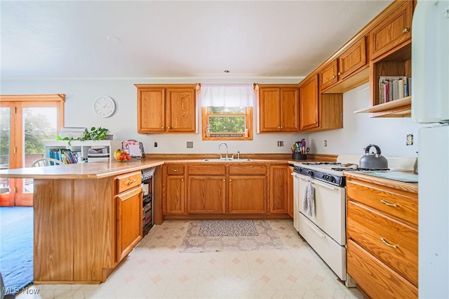 22 Waynesburg Rd NW, Carrollton, OH 44615 - kitchen with white appliances, a sink, a peninsula, and healthy amount of natural light