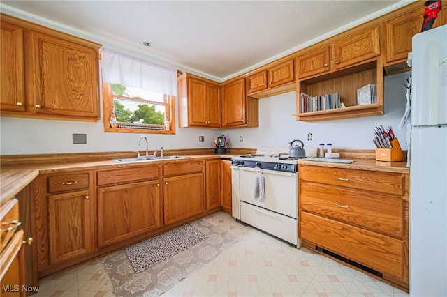 22 Waynesburg Rd NW, Carrollton, OH 44615 - kitchen with a sink, white appliances, and brown cabinets