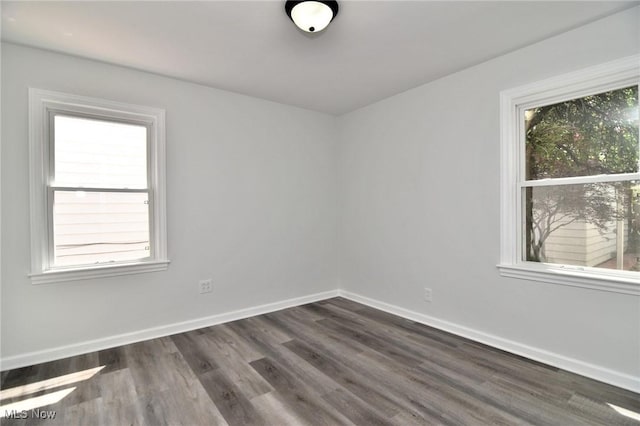 3890 Grosvenor Rd, South Euclid, OH 44118 - empty room featuring healthy amount of natural light, dark wood-style flooring, and baseboards