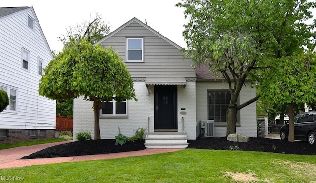 3890 Grosvenor Rd, South Euclid, OH 44118 - view of front of property featuring entry steps, a front lawn, and brick siding
