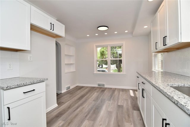 3890 Grosvenor Rd, South Euclid, OH 44118 - kitchen with recessed lighting, decorative backsplash, light wood-style floors, and white cabinetry