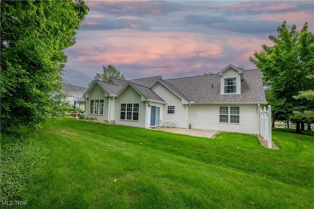 3347 Reserve Dr Unit 36, Cuyahoga Falls, OH 44223 - back of house with a patio area, a lawn, and roof with shingles