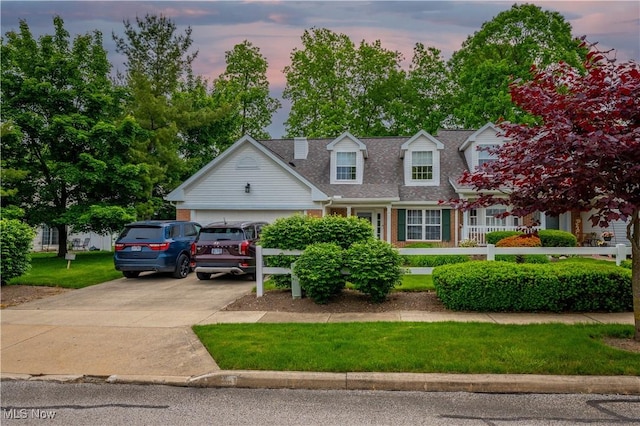 3347 Reserve Dr Unit 36, Cuyahoga Falls, OH 44223 - cape cod home with concrete driveway, a shingled roof, a garage, brick siding, and a front yard
