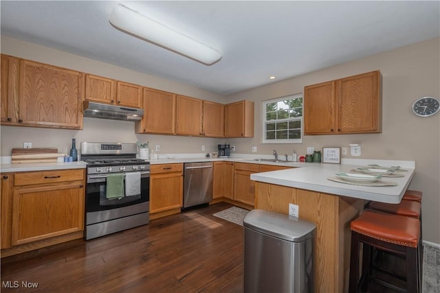3347 Reserve Dr Unit 36, Cuyahoga Falls, OH 44223 - kitchen with stainless steel appliances, under cabinet range hood, a peninsula, a sink, and light countertops