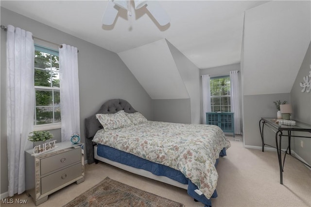 3347 Reserve Dr Unit 36, Cuyahoga Falls, OH 44223 - bedroom with carpet, multiple windows, vaulted ceiling, baseboards, and a ceiling fan