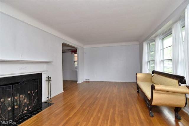 3927 Princeton Blvd, South Euclid, OH 44121 - sitting room with wood finished floors, arched walkways, plenty of natural light, and a tile fireplace